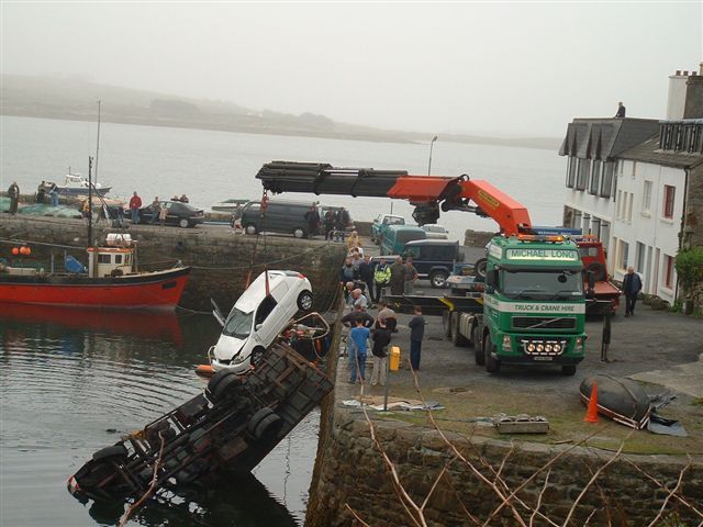 Scene 5 -- Second crane retrieving white automobile.